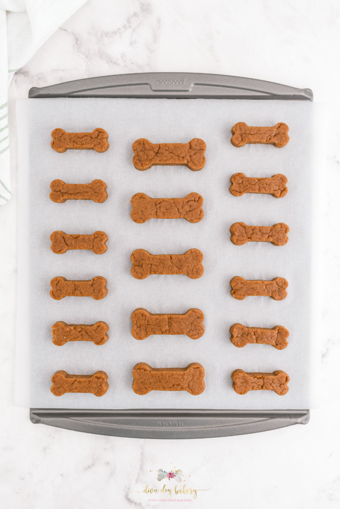 Peanut butter dog treats on cookie sheet; bake at 350 degrees for 15-20 minutes for fully cooked dog treats.